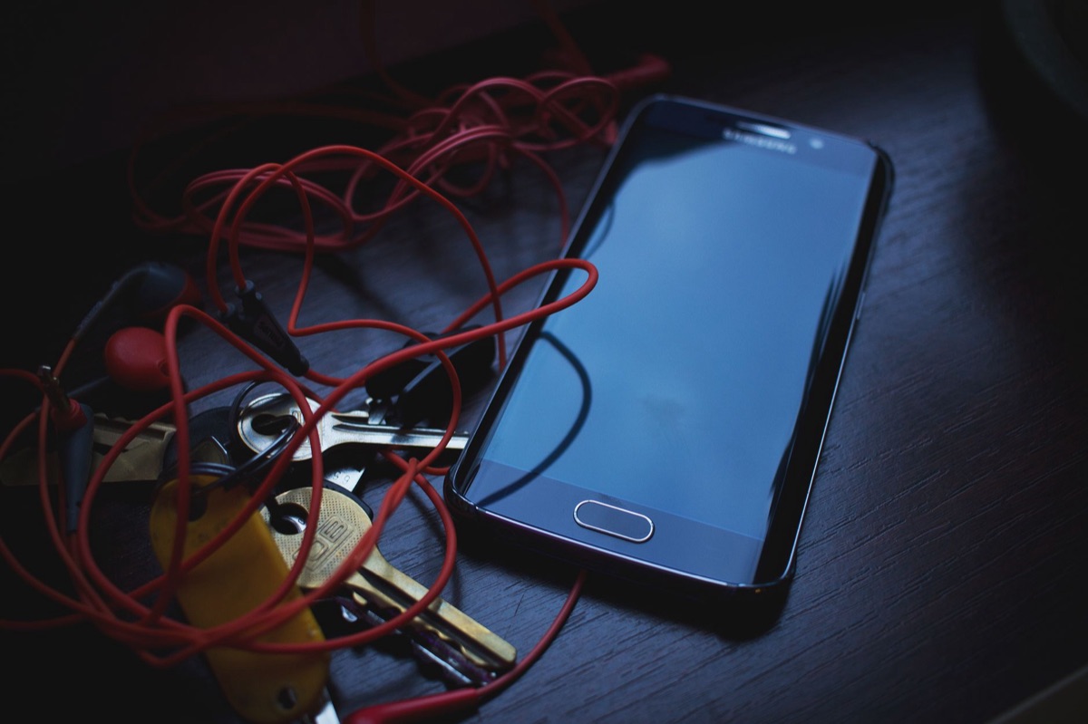 bedroom with tangled wires and charging devices