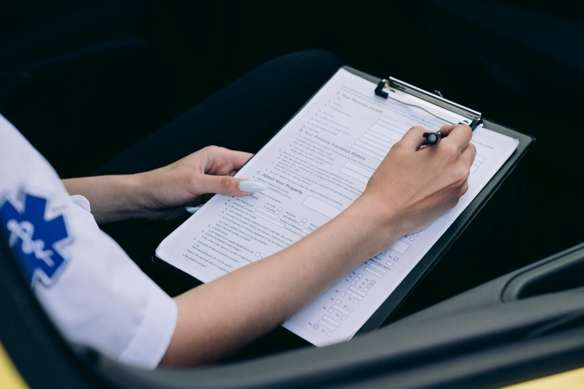 A completed accident report form held on a clipboard, symbolizing incident documentation.